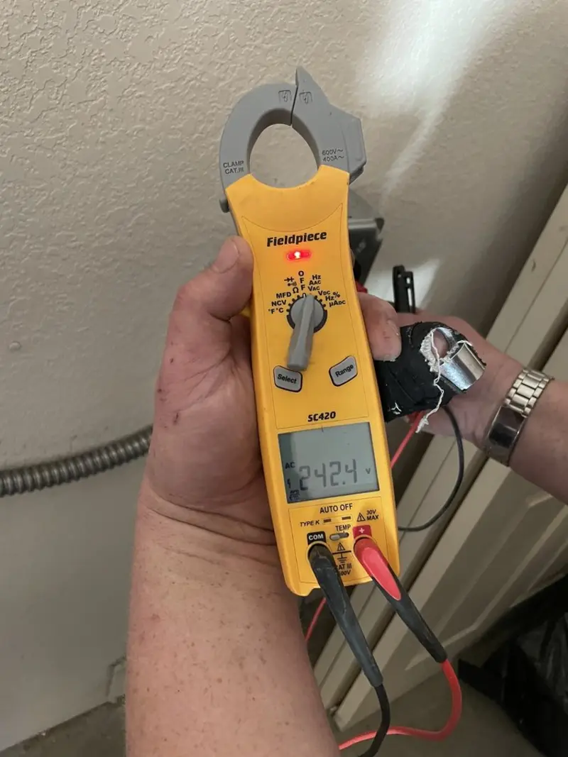Voltage testing with clamp meter during Outlet Installation in Girard